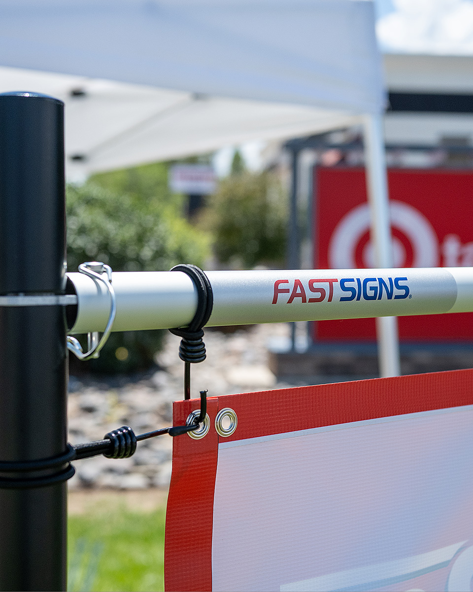 Banner Bar hardware close-up with FastSigns branded bar